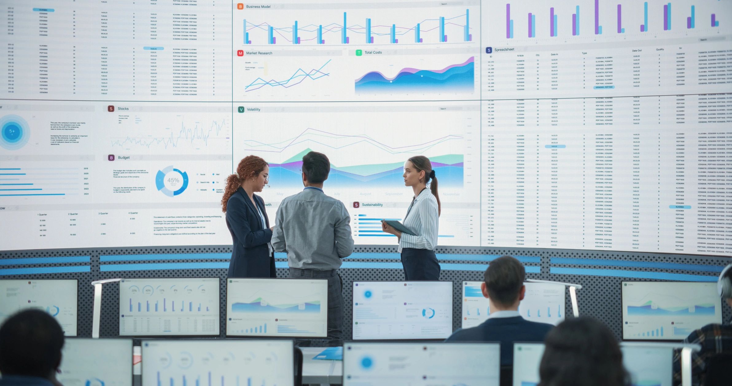Team reviewing digital dashboards in a modern technology office
