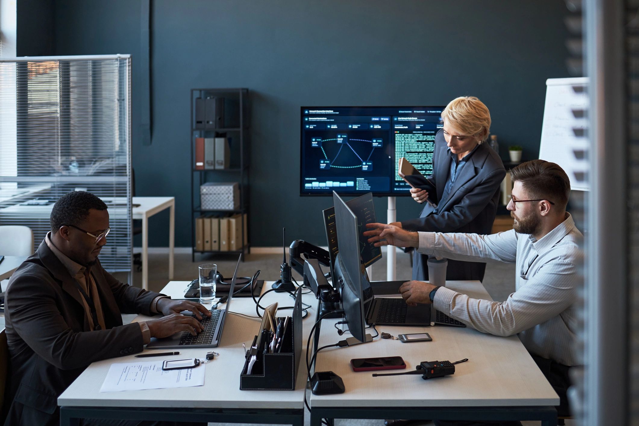 Diverse business team reviewing cybersecurity data in office